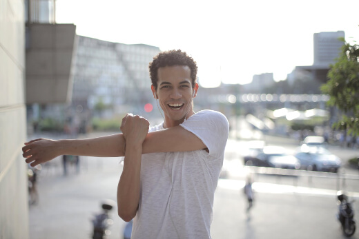 Man doing cross-body arm stretch